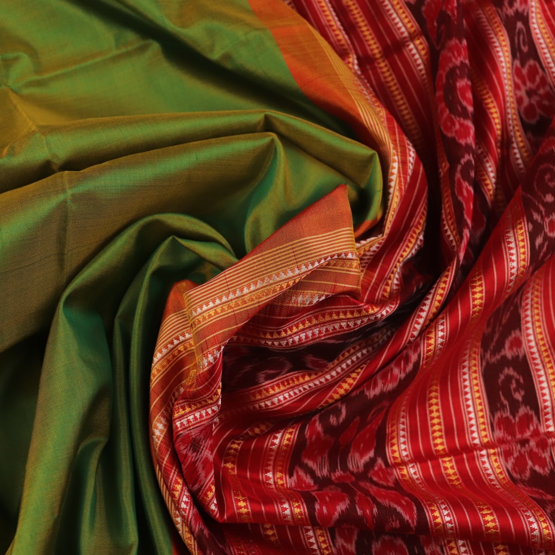 Close-up of plain green Sambalpuri silk saree fabric texture.