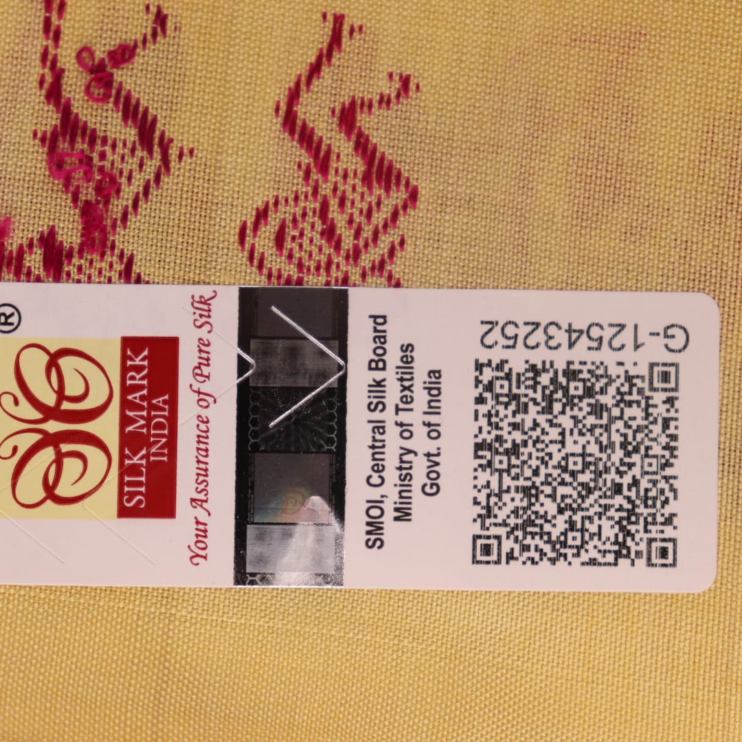 Close-up texture of pink and cream handloom Bomkai silk saree with butta pattern.