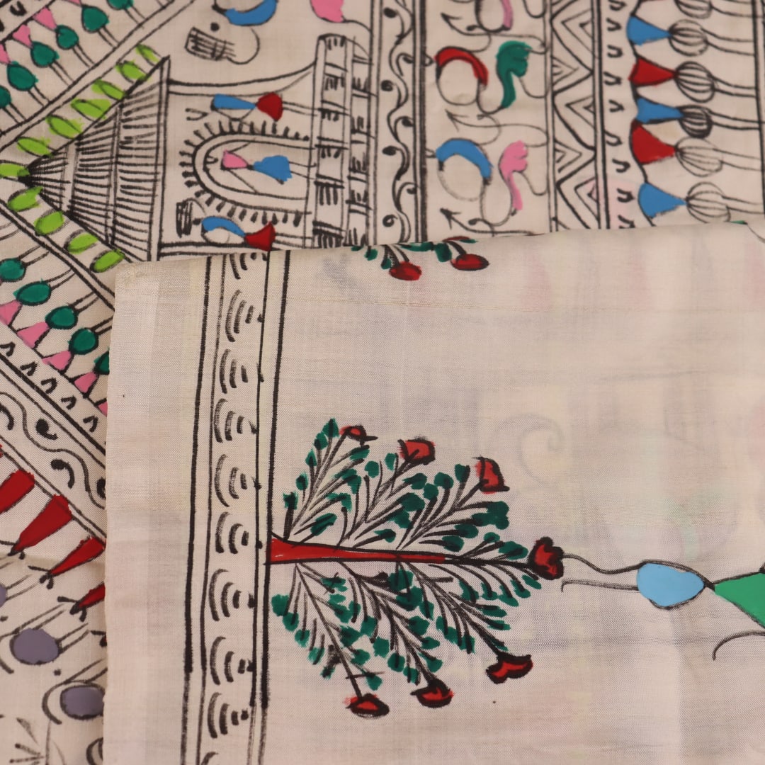 Close-up of the white silk saree fabric texture, showcasing the handloom weave and painted Patachitra details.