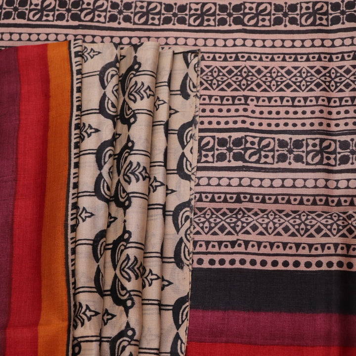 Close-up of off-white Tussar silk fabric, highlighting natural slubs and printed black pattern.