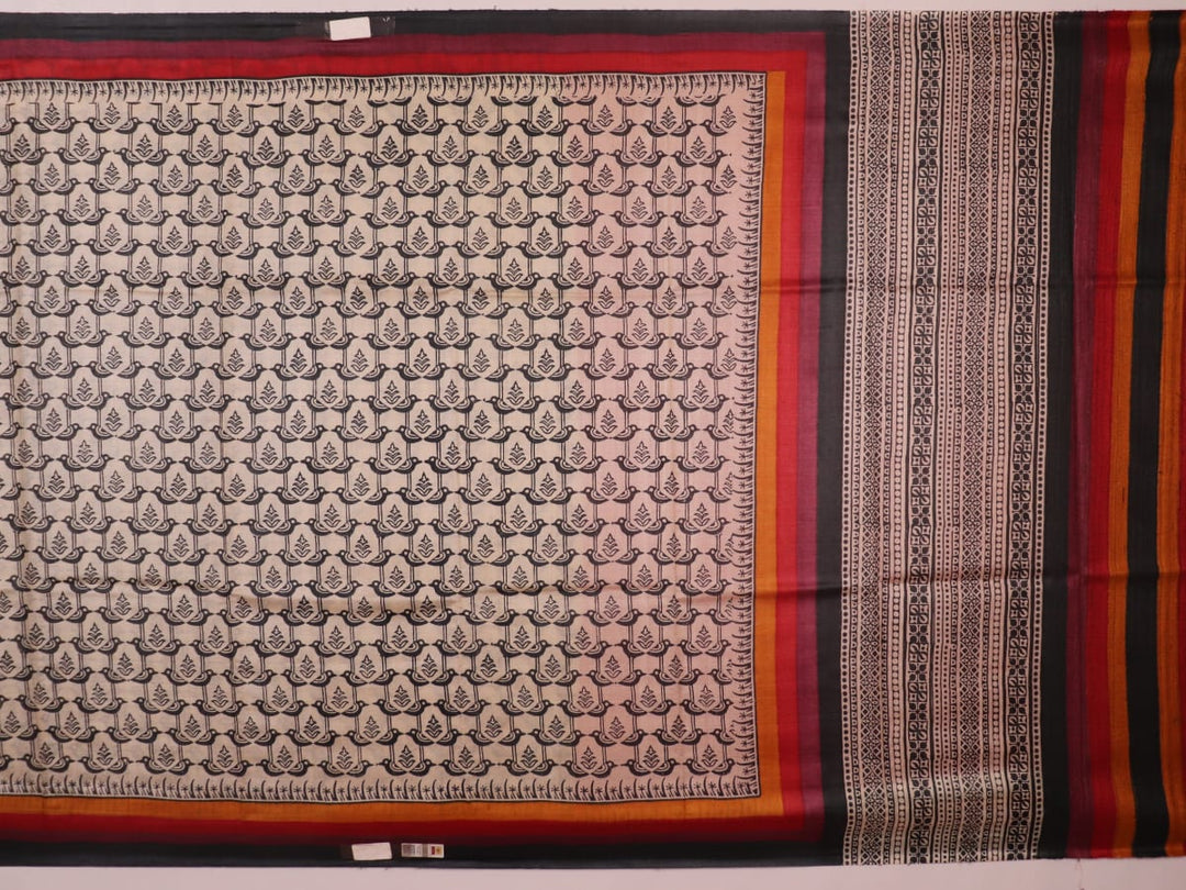 Close-up of off-white Tussar silk fabric, highlighting natural slubs and printed black pattern.