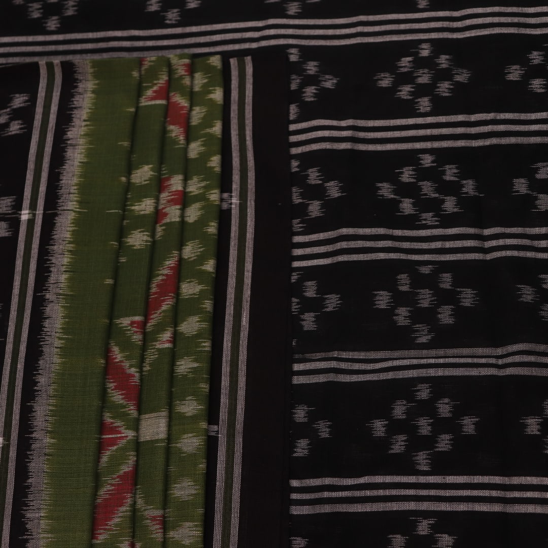 Green and black Sambalpuri cotton saree with motifs, elegantly draped.
