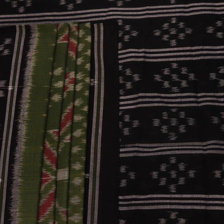Green and black Sambalpuri cotton saree with motifs, elegantly draped.