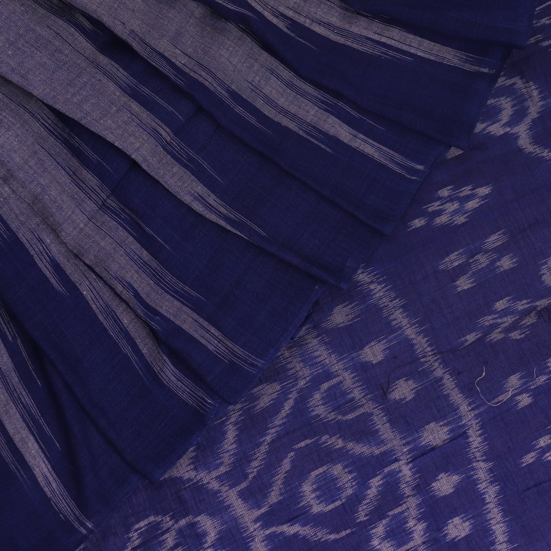 Blue plain Sambalpuri cotton saree styled, highlighting its simple elegance and drape.