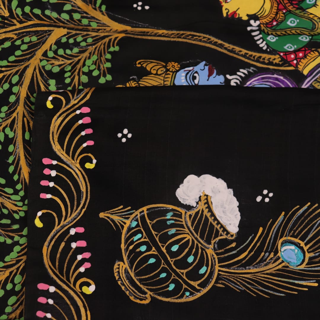 Close-up of black silk Patachitra saree fabric, showcasing hand-painted texture and detail.