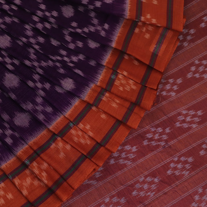 Violet & rust Sambalpuri cotton saree with motifs, elegantly draped.