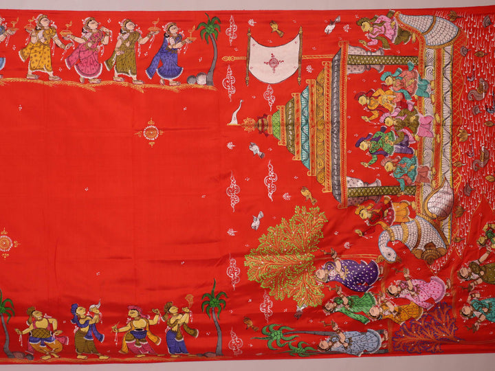 Close-up of red Patachitra silk saree fabric showing hand-painted texture.