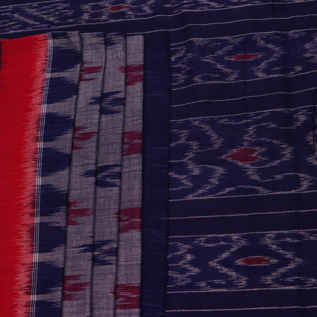 Blue Sambalpuri cotton saree with motifs, gracefully draped.