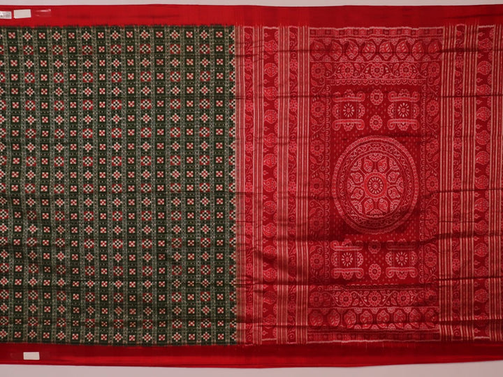 Close-up of green Sambalpuri silk saree fabric showing intricate woven motif texture and red thread details.