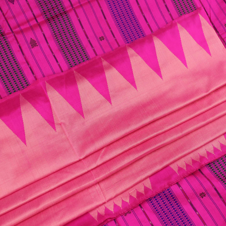 Close-up of plain peach and pink Sambalpuri silk saree fabric texture.