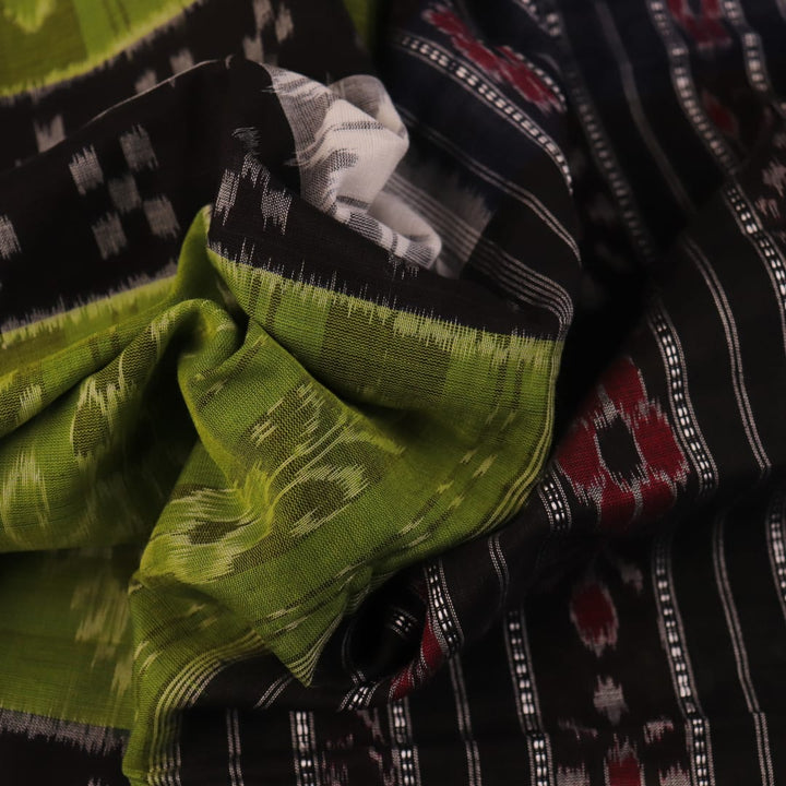 Styled green and black cotton Sambalpuri handloom saree with motifs, showcasing its elegant drape.