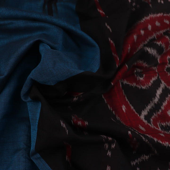 Draped plain blue and black Sambalpuri cotton saree.