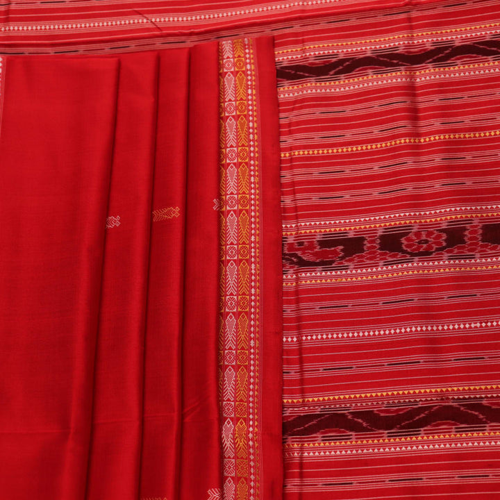 Close-up of the distinct handwoven texture of a red Sambalpuri silk saree with Butta pattern.