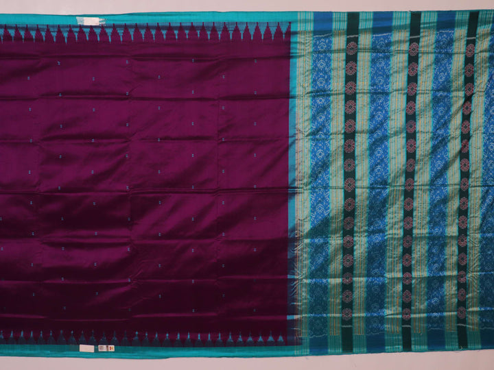Close-up of the textured weave of a purple Sambalpuri silk saree with green accents and butta pattern.