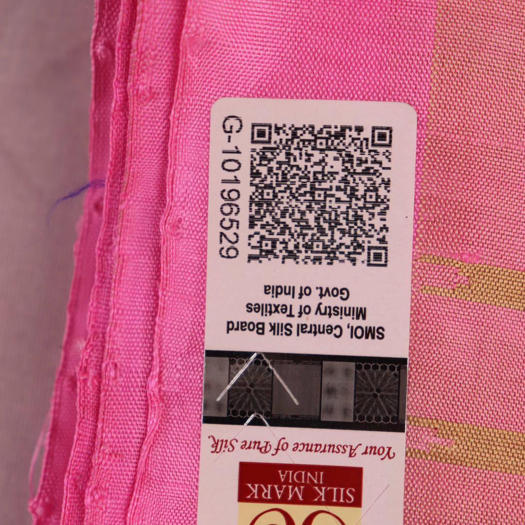 Close-up of green and pink plain Sambalpuri silk saree fabric texture.