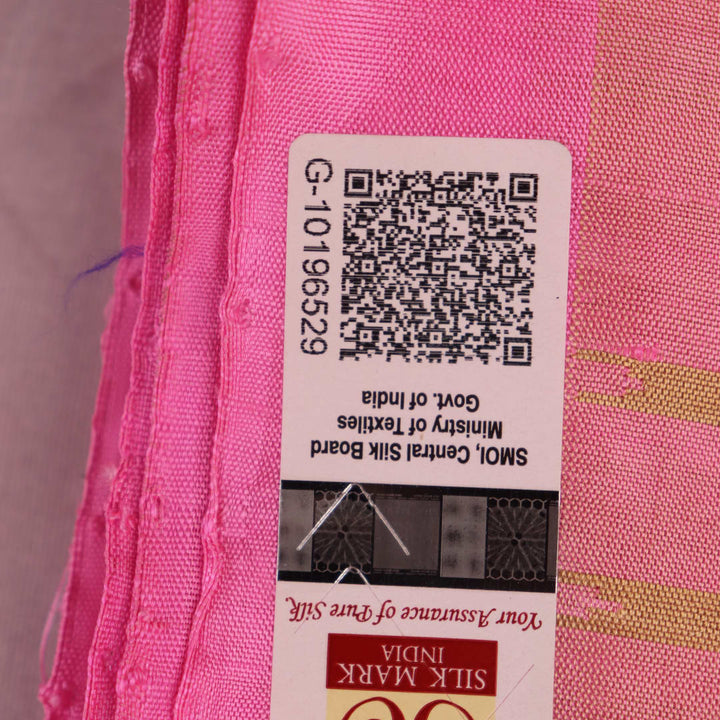 Close-up of green and pink plain Sambalpuri silk saree fabric texture.