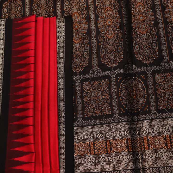 Detailed close-up of the red and black Bomkai silk saree fabric texture, featuring a butta pattern.
