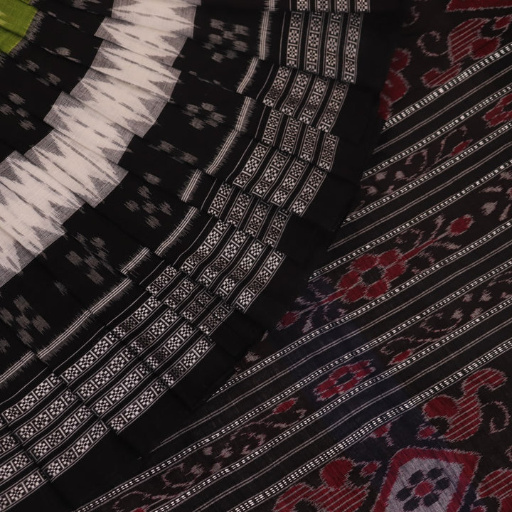 Styled green and black cotton Sambalpuri handloom saree with motifs, showcasing its elegant drape.