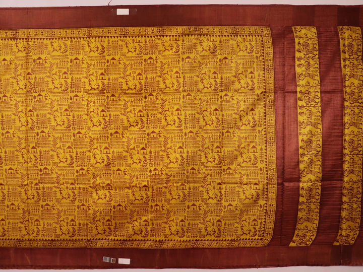 Close-up showing the textured weave of a yellow and brown printed Tussar silk saree.