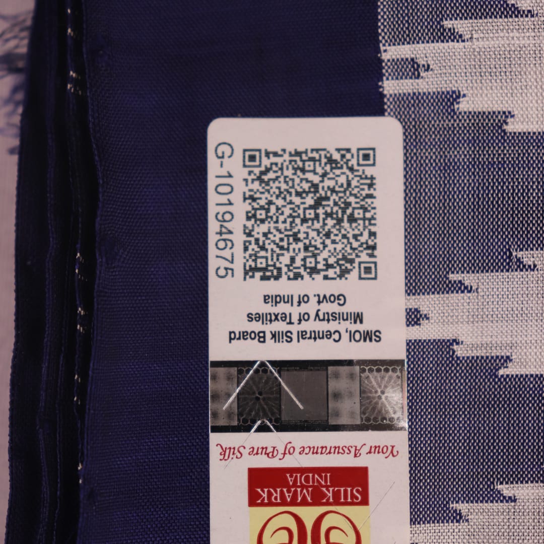 Close-up of white and blue Sambalpuri Silk Saree fabric texture, highlighting butta pattern.