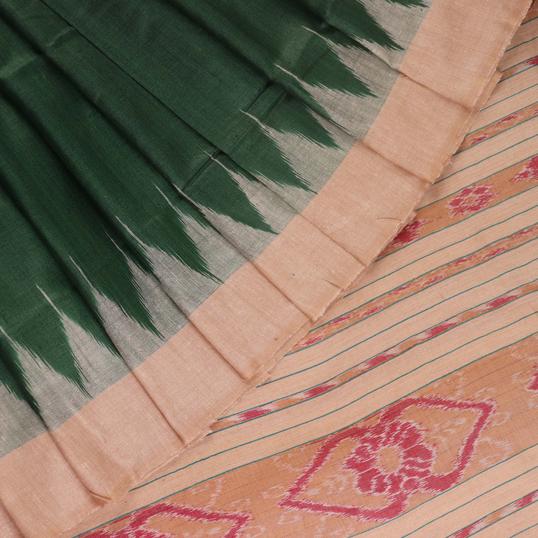 Close-up of the green and off-white plain Tussar silk saree, highlighting its natural slub texture.