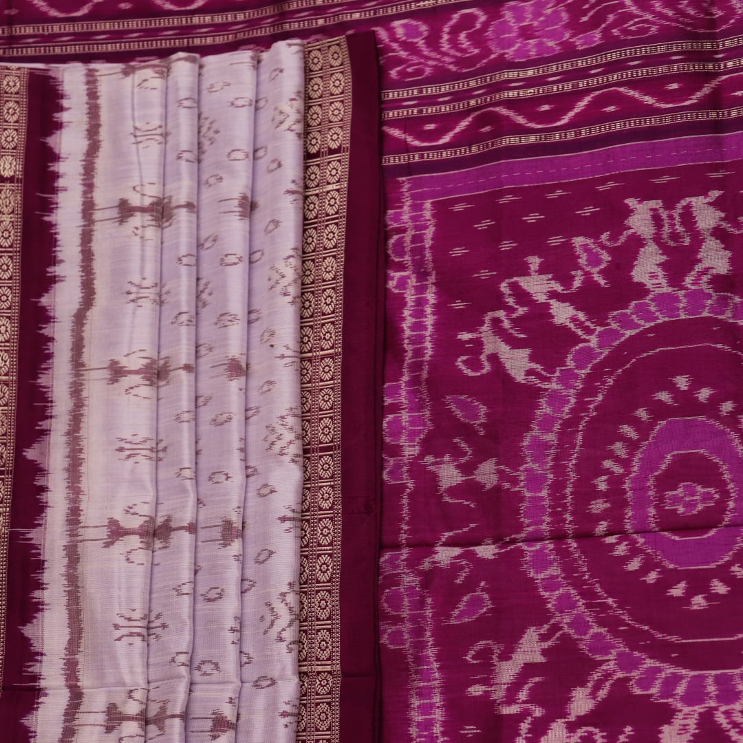 Close-up of silk fabric with intricate Sambalpuri motif design in multicolor and purple hues