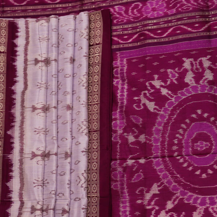 Close-up of silk fabric with intricate Sambalpuri motif design in multicolor and purple hues