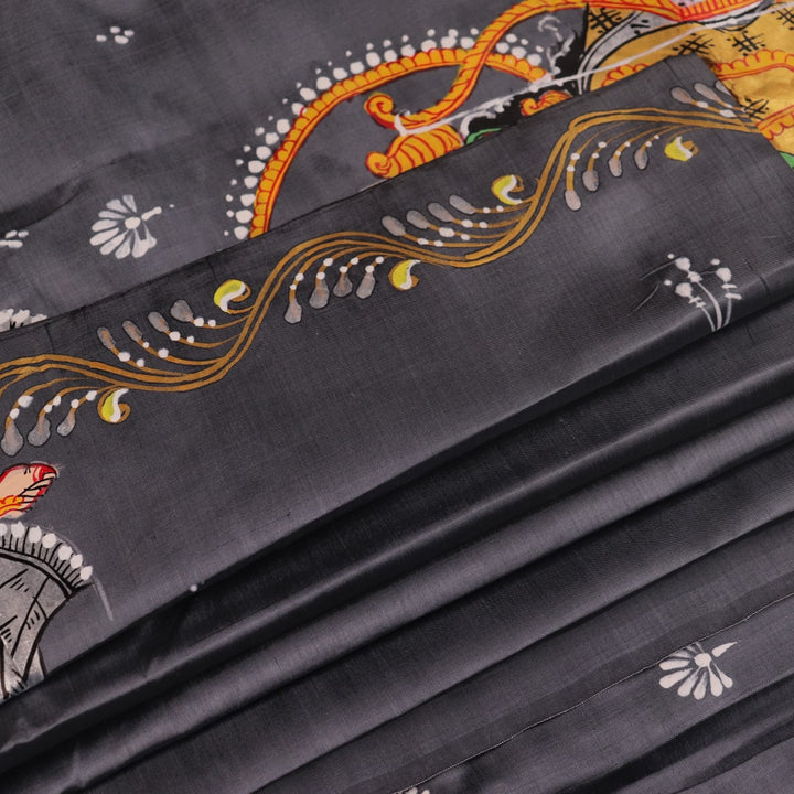 Close-up of handloom grey silk Patachitra saree fabric texture, revealing the intricate details of the hand-painted design.