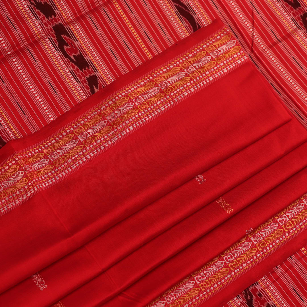 Close-up of the distinct handwoven texture of a red Sambalpuri silk saree with Butta pattern.