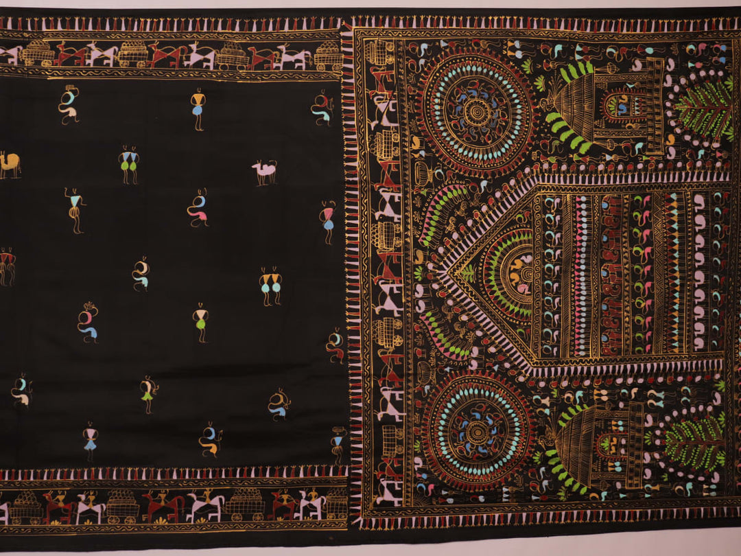 Close-up of the black silk Patachitra saree, showcasing the hand-painted fabric texture.