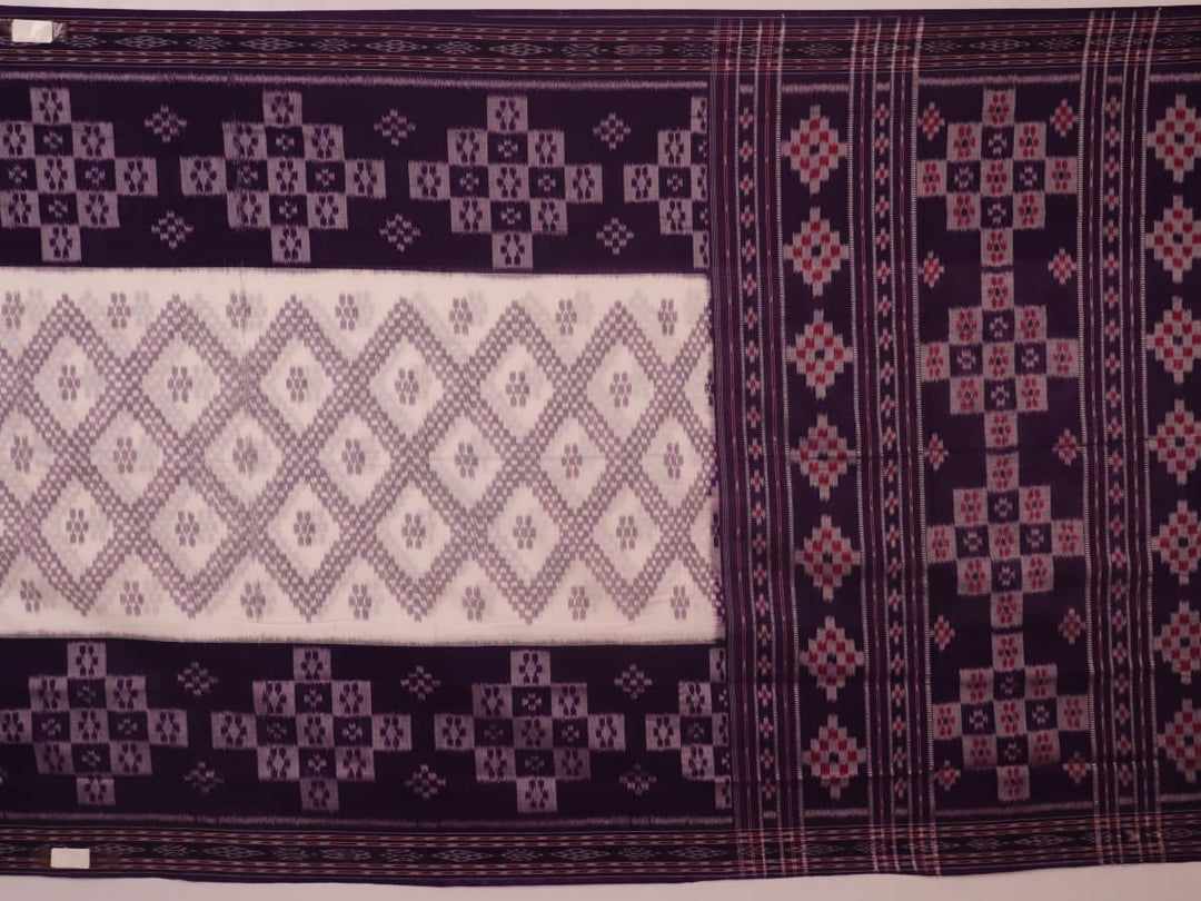 Elegantly draped red and violet Sambalpuri cotton saree with traditional motifs.