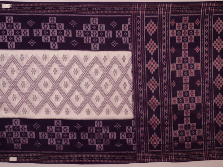 Elegantly draped red and violet Sambalpuri cotton saree with traditional motifs.