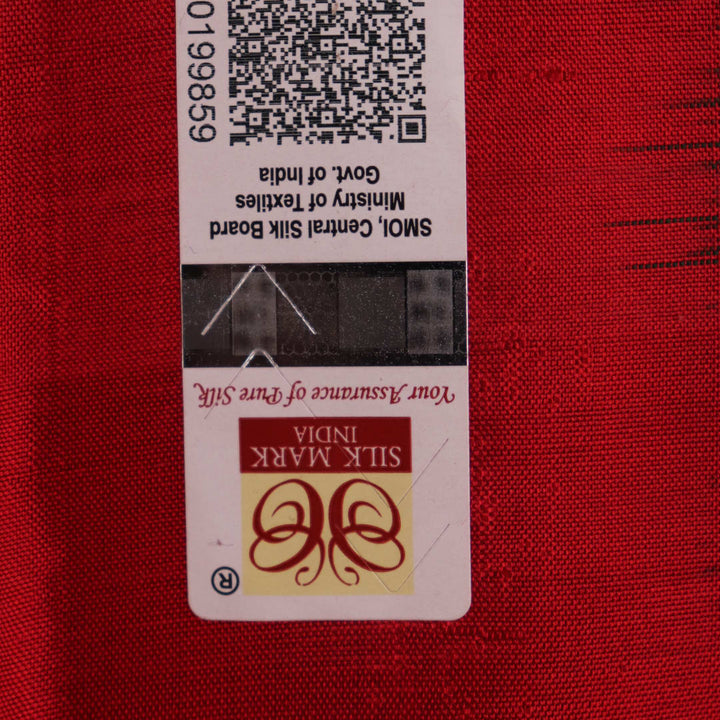 Close-up of green Sambalpuri silk saree fabric showing intricate woven motif texture and red thread details.
