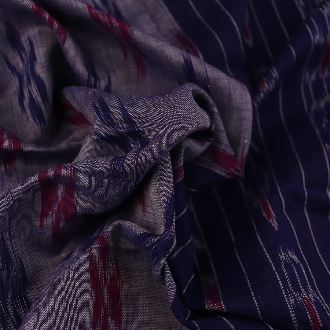 Blue Sambalpuri cotton saree with motifs, gracefully draped.