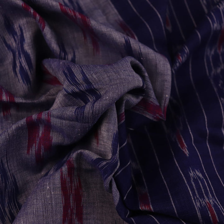 Blue Sambalpuri cotton saree with motifs, gracefully draped.
