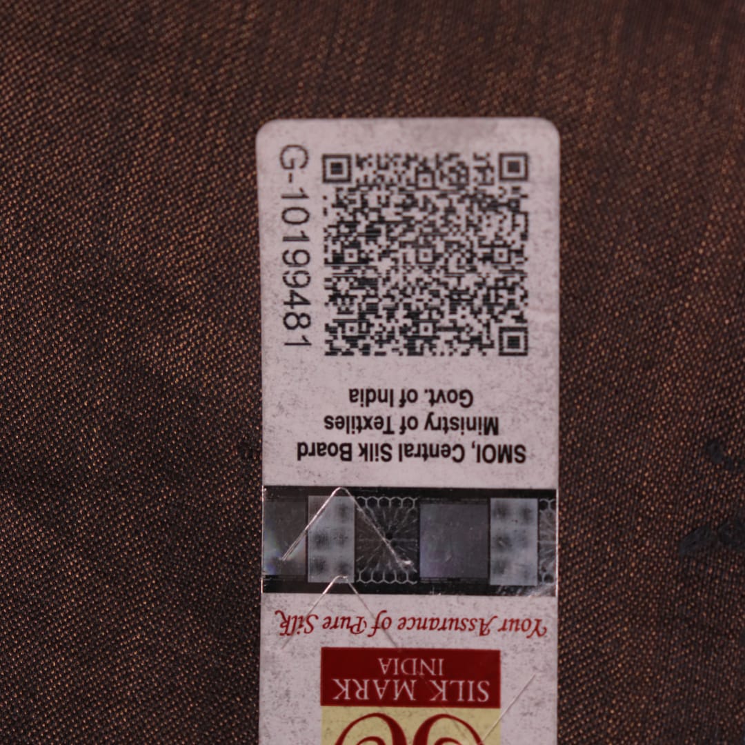 Close-up of the natural slub texture of grey printed Tussar silk saree fabric.