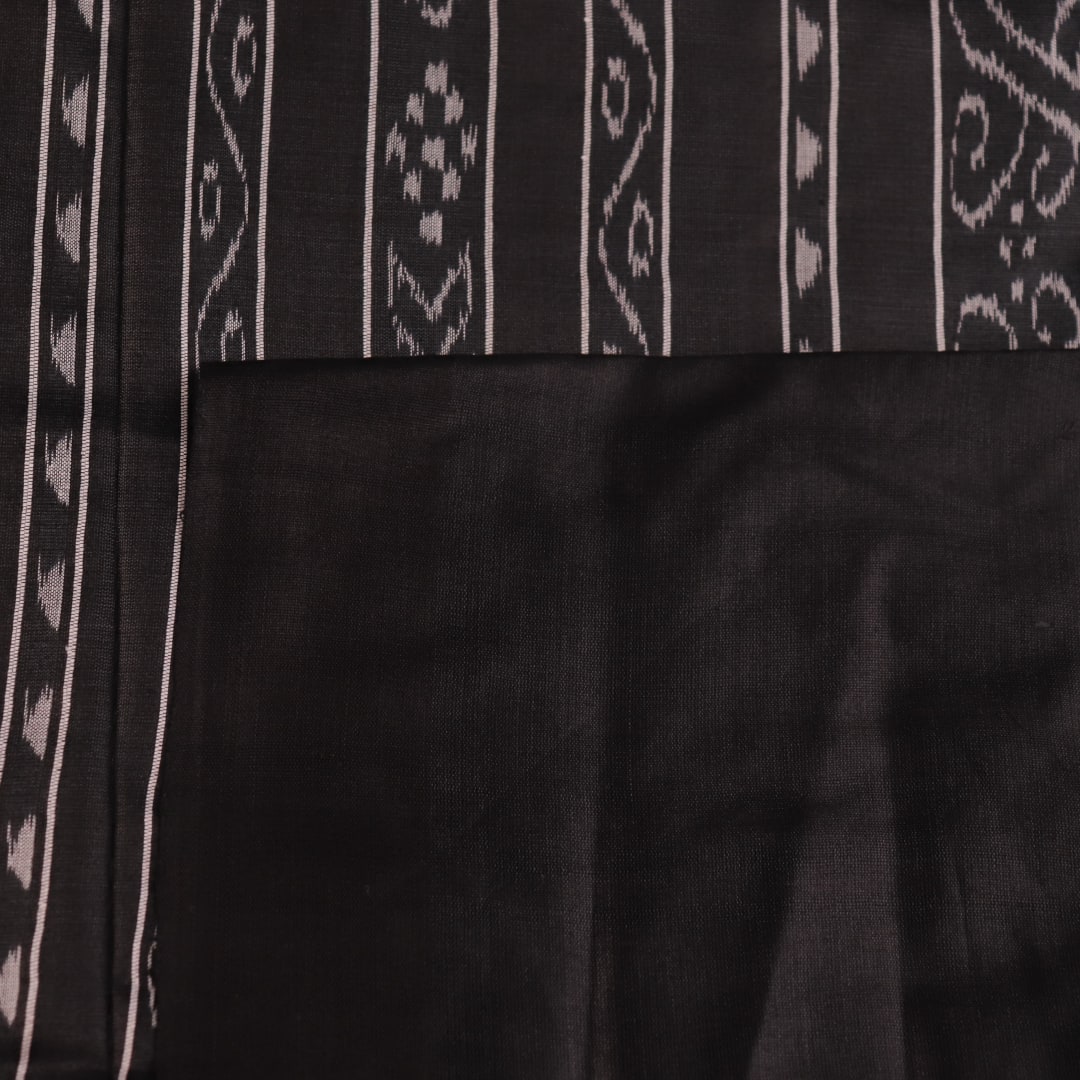 Close-up of the plain, slubby texture of a handwoven green and black Tussar silk saree.