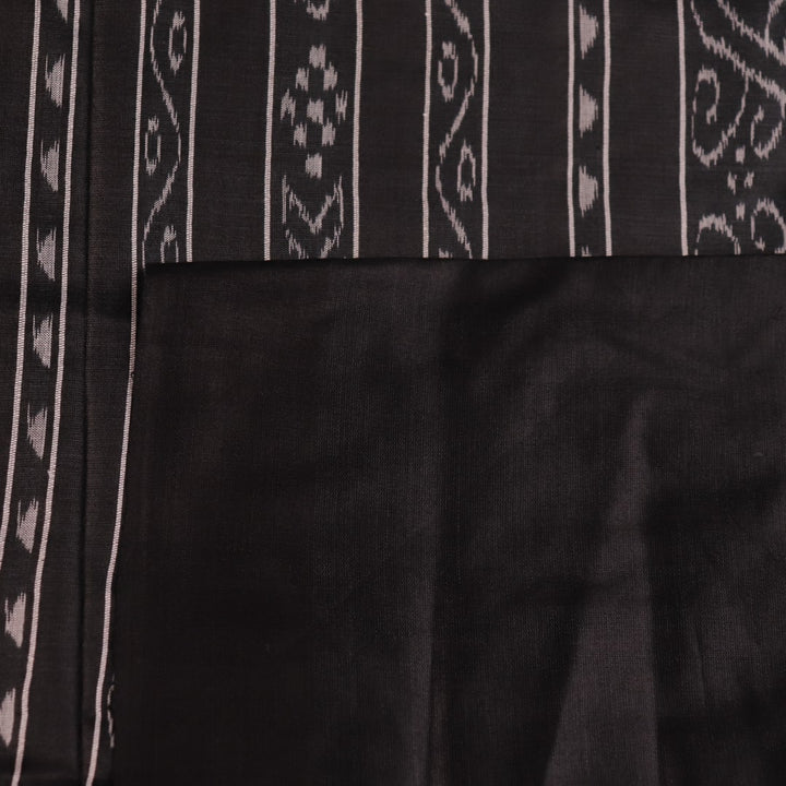 Close-up of the plain, slubby texture of a handwoven green and black Tussar silk saree.