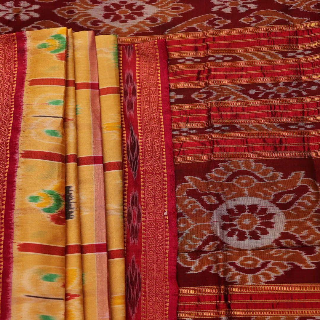 Saree draped to showcase the Nabakothi pattern, red border, and multi-colored silk Khandua handloom artistry.