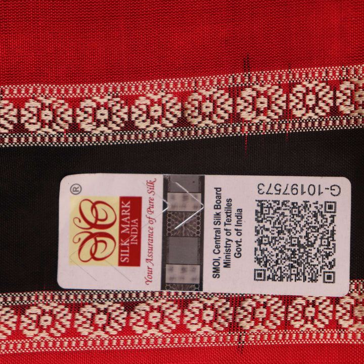 Close-up of Bomkai silk saree fabric texture in black and red, detailing the woven butta pattern.
