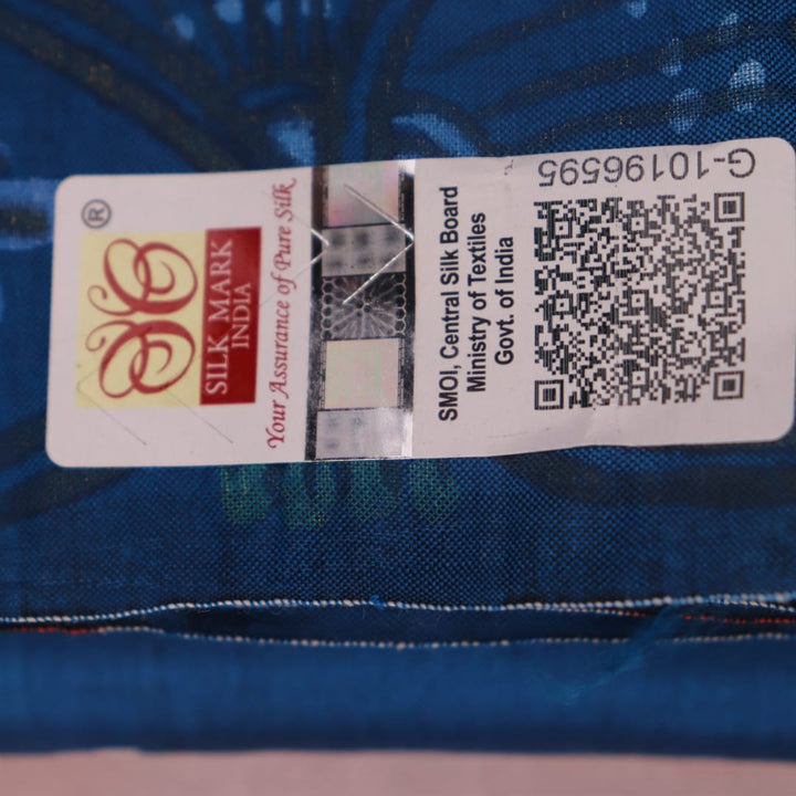 Close-up of handloom blue silk Patachitra saree fabric, showcasing the fine texture and hand-painted details.