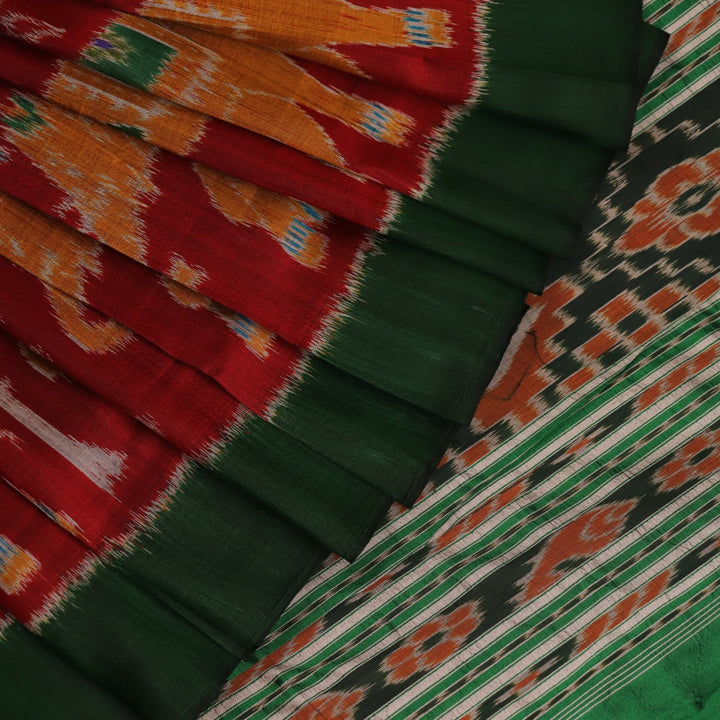 Maroon and green Khandua silk saree with intricate motifs draped elegantly
