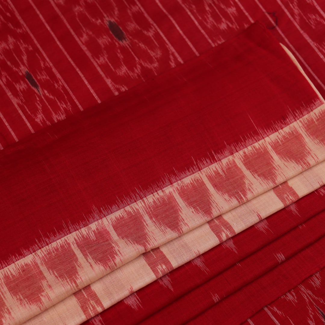 Cream and red Sambalpuri cotton saree with motifs elegantly draped on a person.