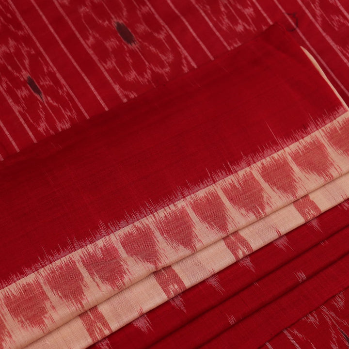 Cream and red Sambalpuri cotton saree with motifs elegantly draped on a person.