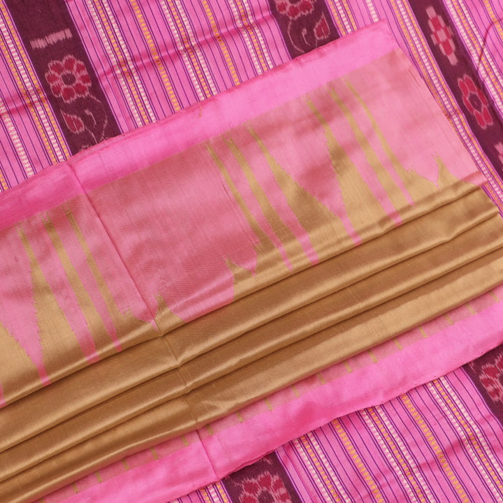Close-up of green and pink plain Sambalpuri silk saree fabric texture.