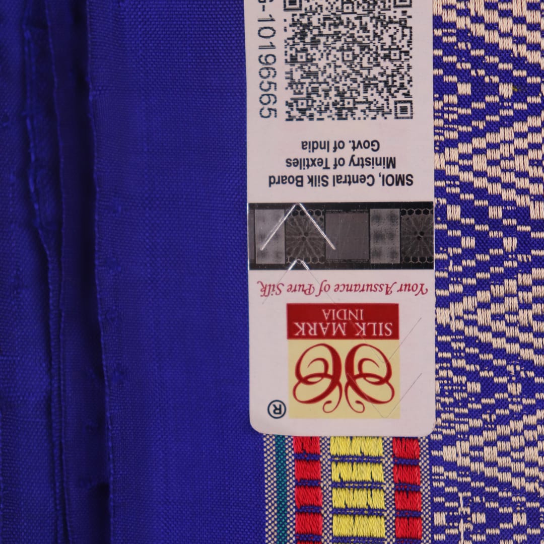 Close-up of green and blue Dongria silk saree fabric texture with butta pattern.