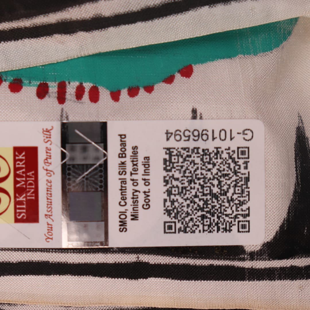 Close-up of white silk Patachitra saree fabric showing hand-painted texture and detail.