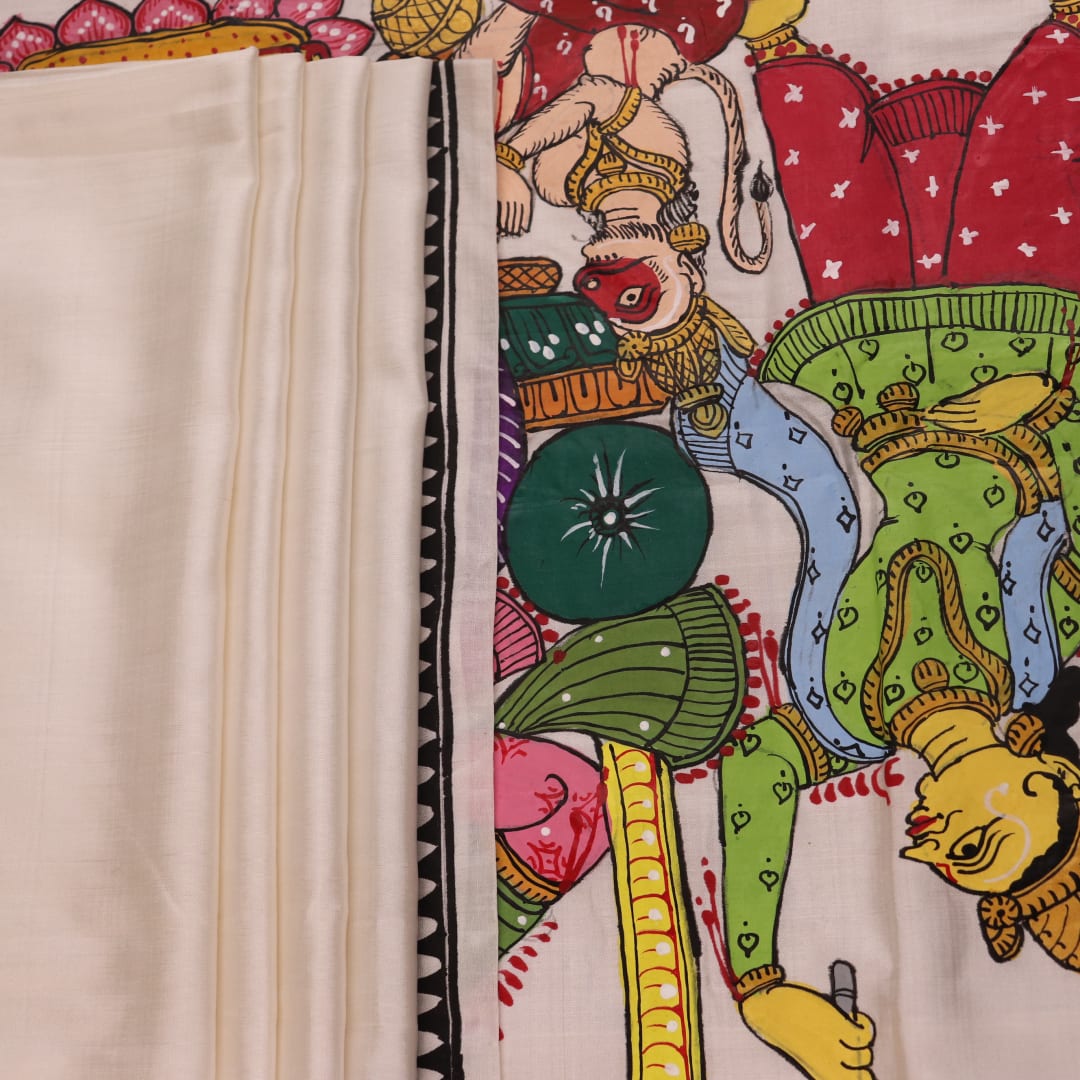 Close-up of handloom white silk Patachitra saree fabric showing texture and hand-painted details.