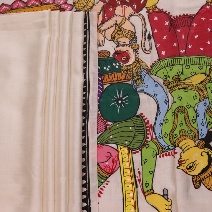 Close-up of handloom white silk Patachitra saree fabric showing texture and hand-painted details.
