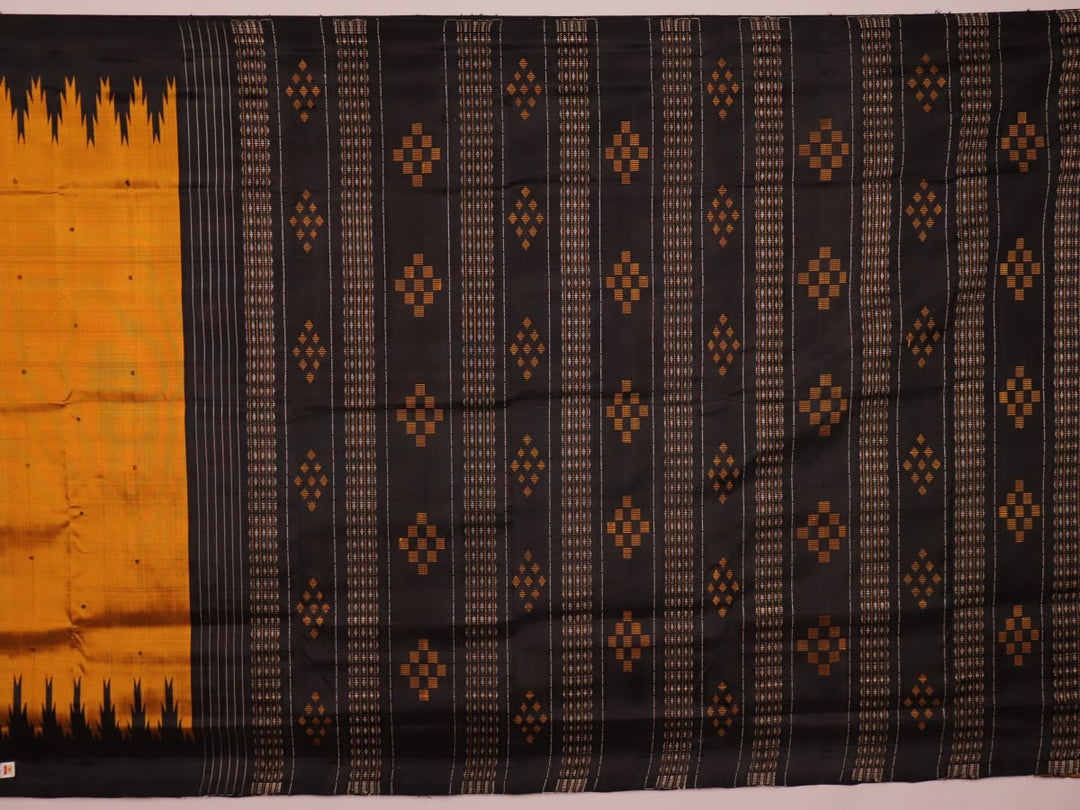 Close-up of shimmering gold silk fabric with intricate butta motifs